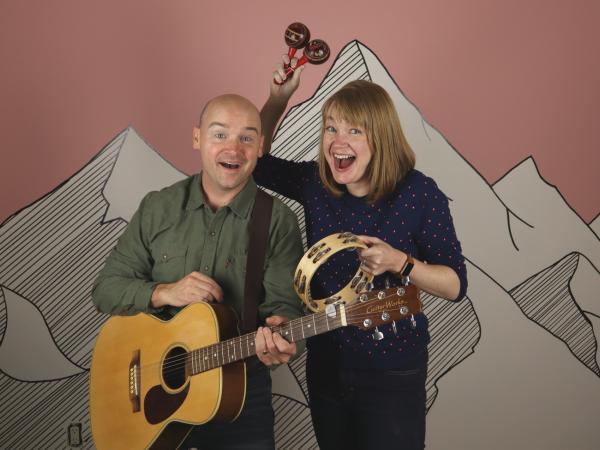 A man and woman holding their instruments